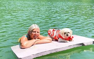 Jill and pet dog Bella on the lake